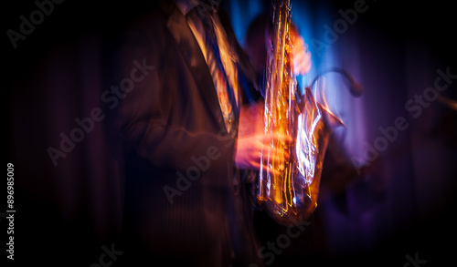 Canvas Print Abstract motion blurred image of a jazz saxaphonist on stage