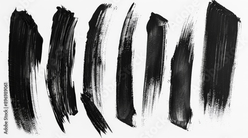 A display of sweeping black brush strokes against a clean, white background. This piece highlights the motion, flow, and energy captured within the brushwork, symbolizing grace and power.