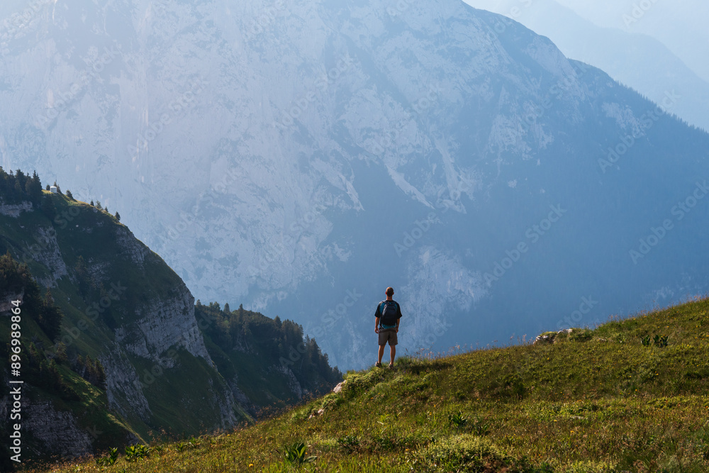 Man, tourist with backpack standing above mountain valley. Loser, Austria alps Man, tourist with backpack standing above mountain valley. Loser, Austria alps