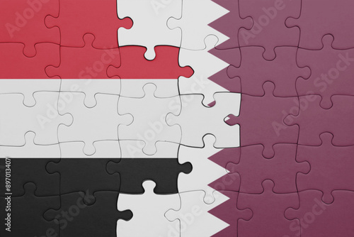 puzzle with the colourful national flag of yemen and flag of qatar . photo