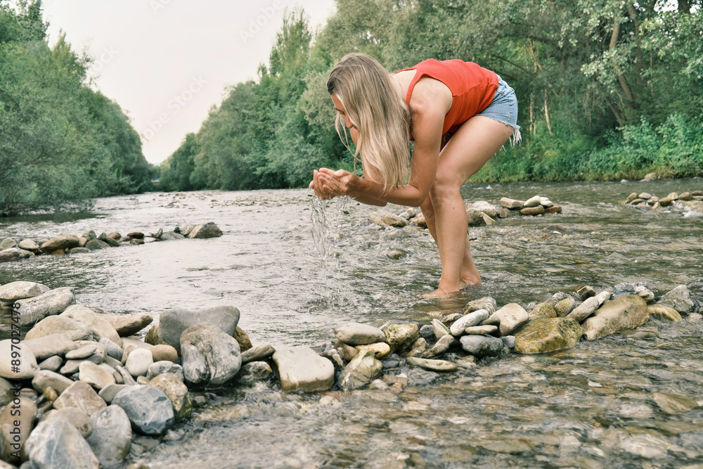 Woman Cools Off in a Mountain River on a Hot Summer Day. Woman Enjoys the Refreshing Waters on a Scorching Day. Refreshing Escape. Cooling Off in a Mountain River. Woman Cools Off in a Mountain River on a Hot Summer Day. Woman Enjoys the Refreshing Waters on a Scorching Day. Refreshing Escape. Cooling Off in a Mountain River.