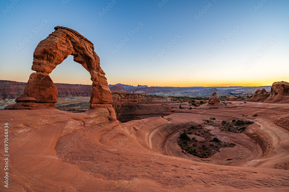 Delicate Arch - The most famous landmark of the Arches National Park in Utah after sunset in blue hour twilight.