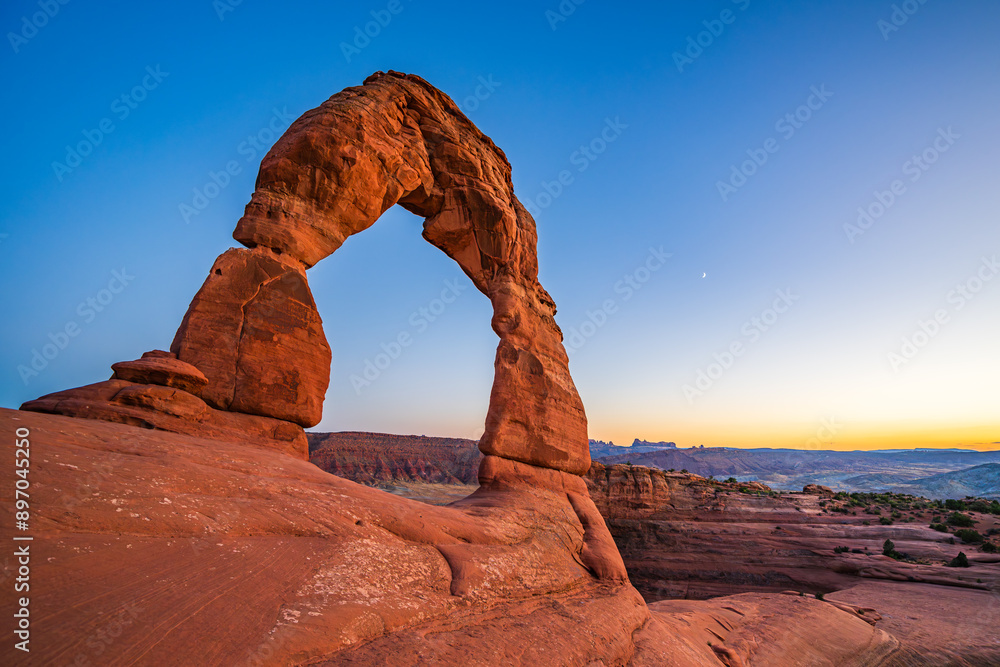 Delicate Arch - The most famous landmark of the Arches National Park in Utah after sunset in blue hour twilight.