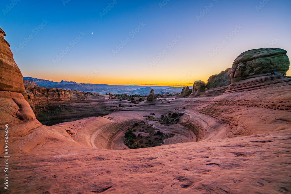 Delicate Arch - The most famous landmark of the Arches National Park in Utah after sunset in blue hour twilight.