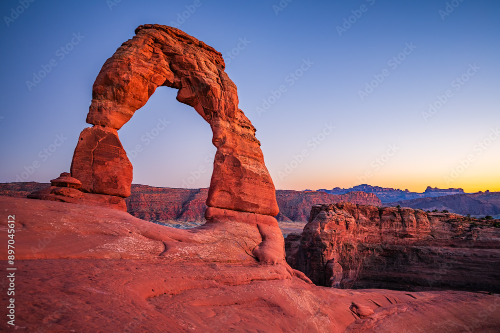 Delicate Arch - The most famous landmark of the Arches National Park in Utah after sunset in blue hour twilight.