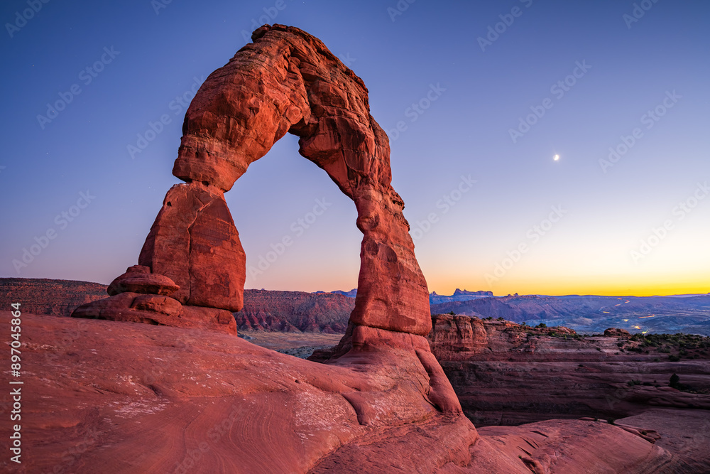 Delicate Arch - The most famous landmark of the Arches National Park in Utah after sunset in blue hour twilight.