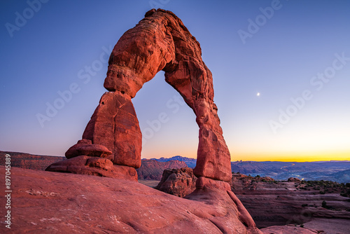 Delicate Arch - The most famous landmark of the Arches National Park in Utah after sunset in blue hour twilight.