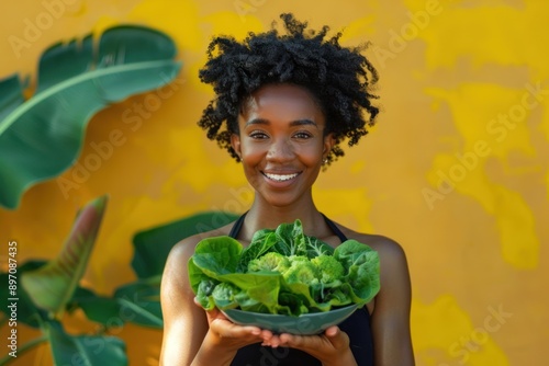 Energetic Woman Holding Bowl of Vibrant Greens, Dedication to Fitness Journey photo