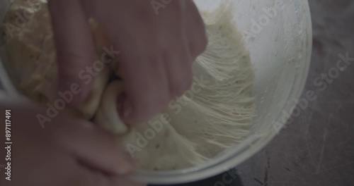 FOOD LOVER SERIES
FOOD LOVER SERIES
A young man preparing a dough to make foccacia bread, with olive oil, flour, water. Real, gourmet, healthy food. Hands are seen working in an indoor space.