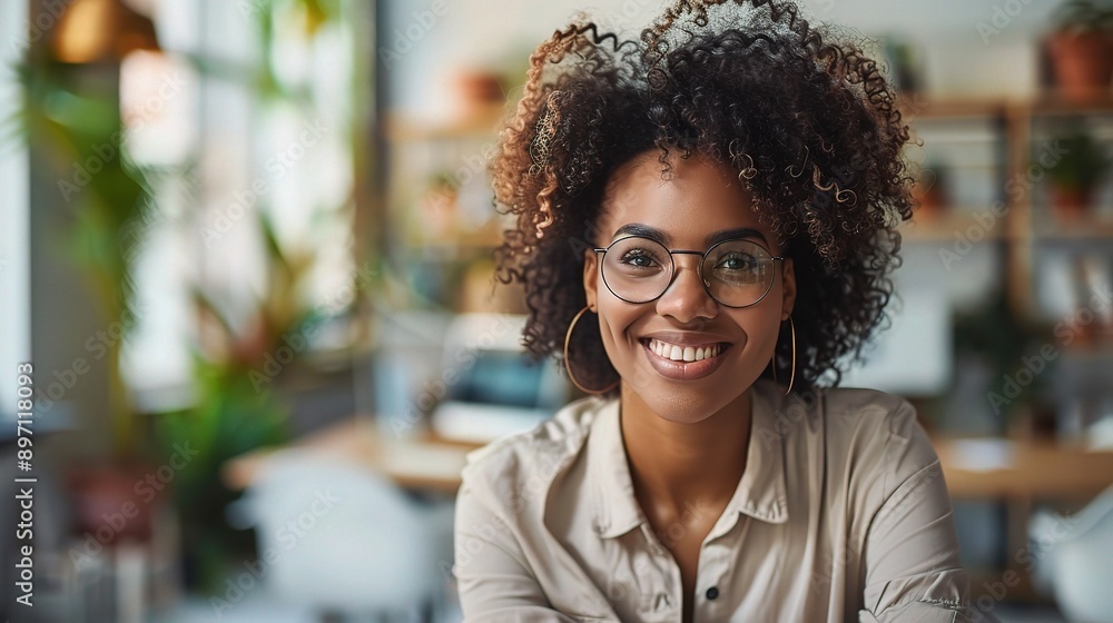Confident Creative: A portrait of a young Black woman with glasses and natural hair, smiling confidently in a modern office setting. Confident Creative: A portrait of a young Black woman with glasses and natural hair, smiling confidently in a modern office setting.