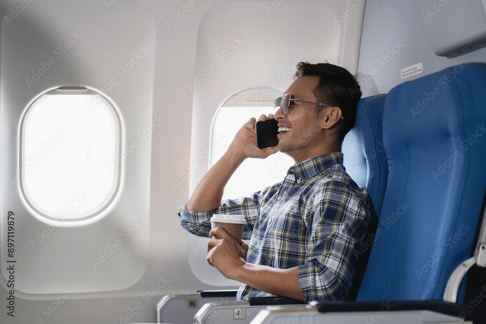 Successful business man, Airplane, travel, enjoying comfortable flight while sitting in the airplane cabin. Successful business man, Airplane, travel, enjoying comfortable flight while sitting in the airplane cabin.