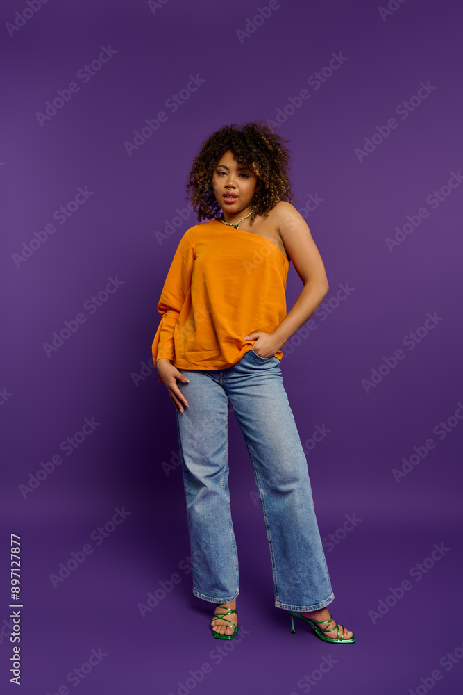 Stylish African American woman standing gracefully against a vibrant purple backdrop. Stylish African American woman standing gracefully against a vibrant purple backdrop.