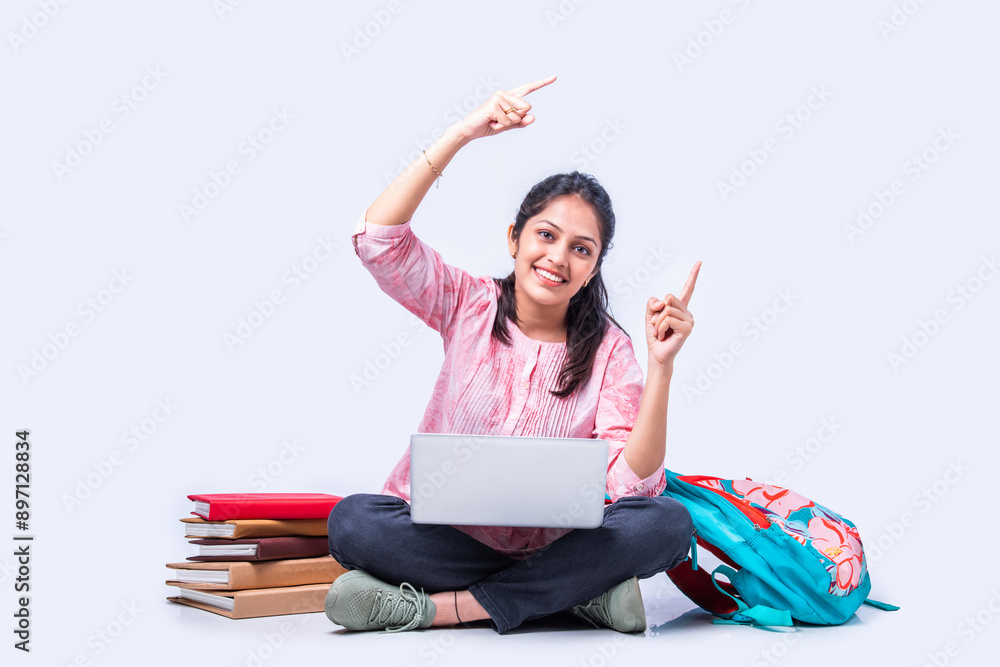 Indian asian pretty young female student studying sitting on white backgrounds Indian asian pretty young female student studying sitting on white backgrounds