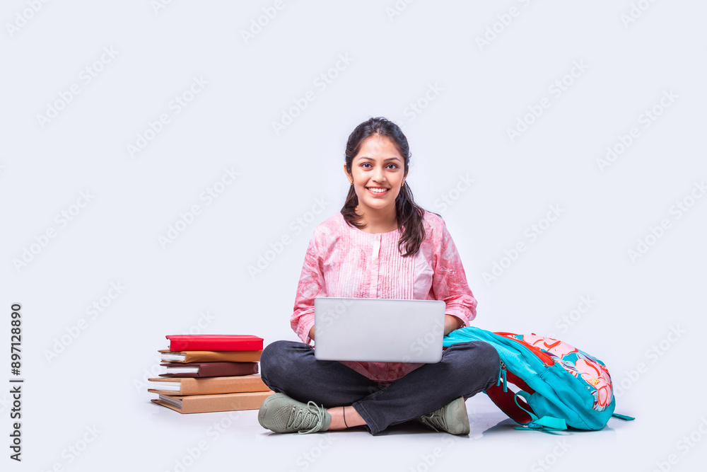 Indian asian pretty young female student studying sitting on white backgrounds Indian asian pretty young female student studying sitting on white backgrounds