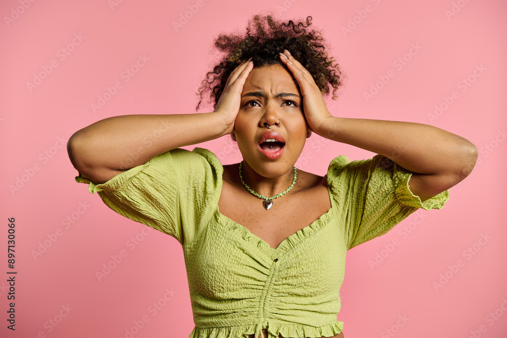 A beautiful African American woman in stylish attire holding her hands to her head in contemplation. A beautiful African American woman in stylish attire holding her hands to her head in contemplation.