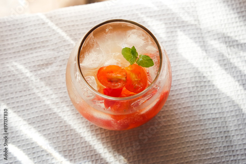 Tomato ade is a common drink in cafe consist of tomato with soda and garnished with mint. photo