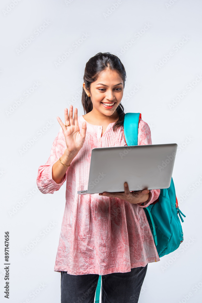 Portrait of happy asian indian young college girl with backpack, laptop and books Portrait of happy asian indian young college girl with backpack, laptop and books