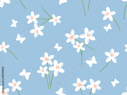 Seamless pattern with white lily flower and butterflies on blue background vector. Cute floral print.