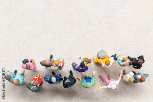 Top-down view of a group of miniature people showing different clothing and poses.