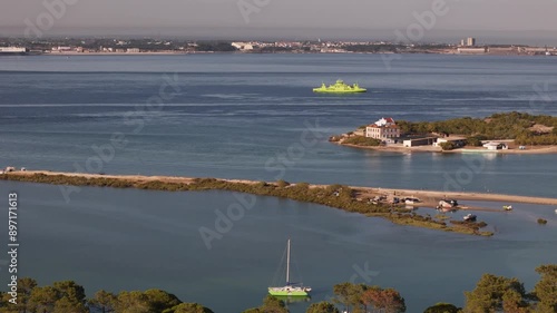Aerial drone approaching ferry boat near Troia in Setubal region of Portugal on a sunny afternoon