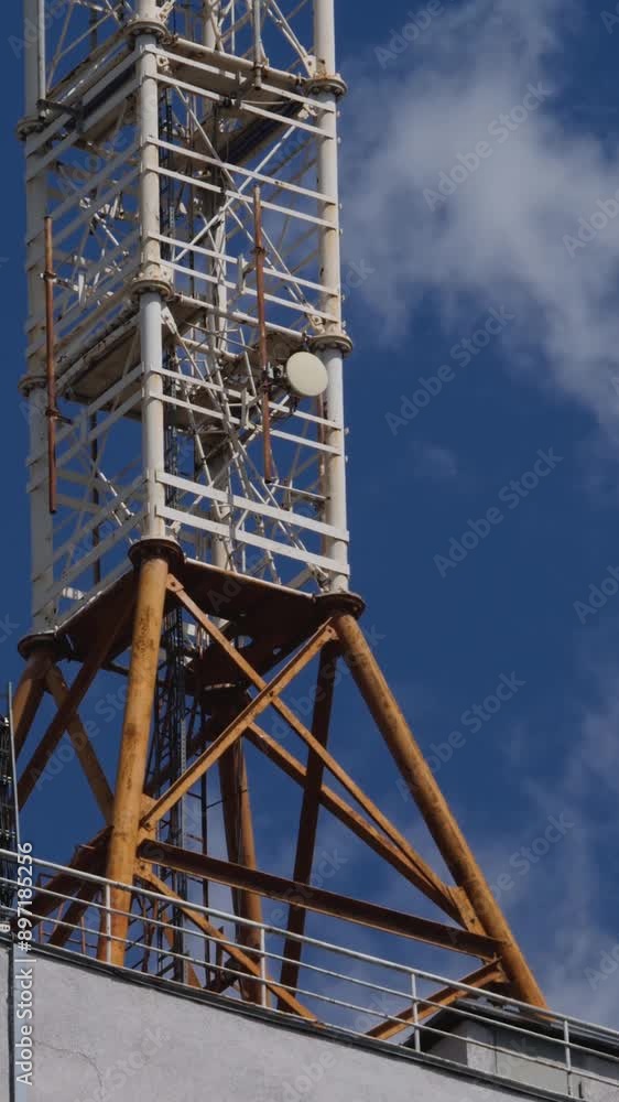 Communication tower on blue sky with white cloud background. Technology of telecommunication GSM tower. Cellular network handheld mobile phones or cell phones Communication tower on blue sky with white cloud background. Technology of telecommunication GSM tower. Cellular network handheld mobile phones or cell phones