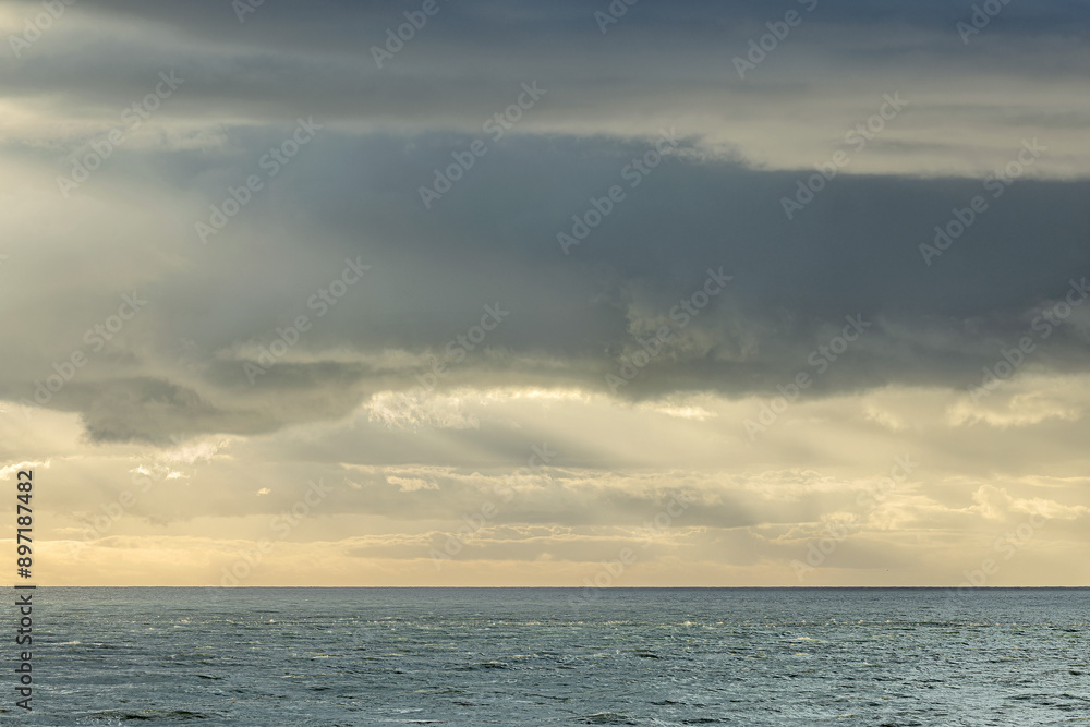 Seascape showing cloudy sky above sea, space for text, winter sunny day, UK England Seascape showing cloudy sky above sea, space for text, winter sunny day, UK England