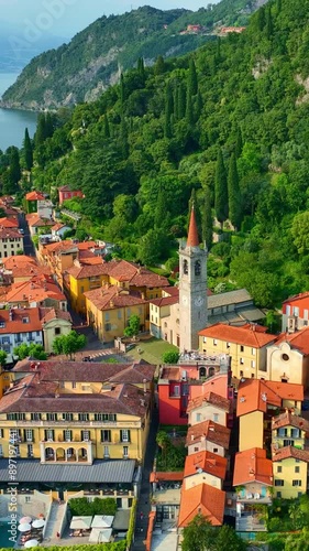 vertical video aerial view of lake Como in Italy, colourful town of Varenna in lake Como at sunset, Lago di Como is a travel holiday destination in Italian Alps