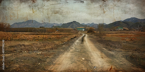 Bitter Harvest: An empty field in a North Korean farming village, with signs of famine and starvation photo