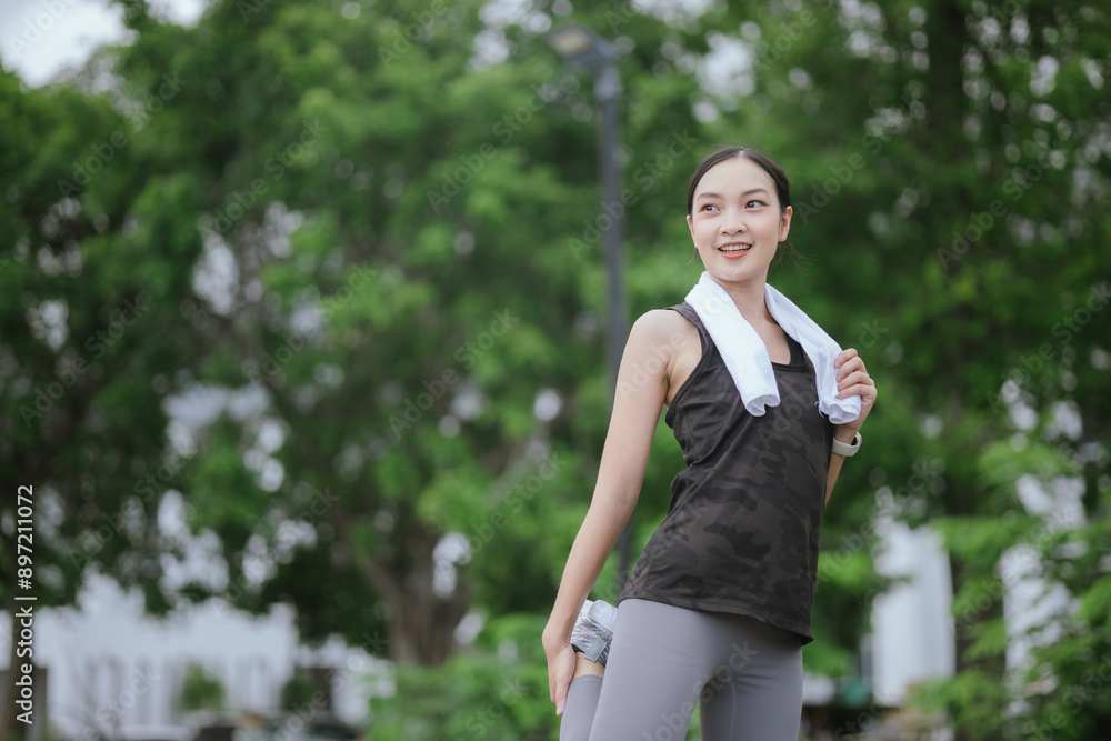 A young, beautiful Asian woman runs happily in a city park on a summer morning. Embracing an active lifestyle, she enjoys outdoor exercise, showcasing fitness, health, vitality, and a joyful, healthy A young, beautiful Asian woman runs happily in a city park on a summer morning. Embracing an active lifestyle, she enjoys outdoor exercise, showcasing fitness, health, vitality, and a joyful, healthy