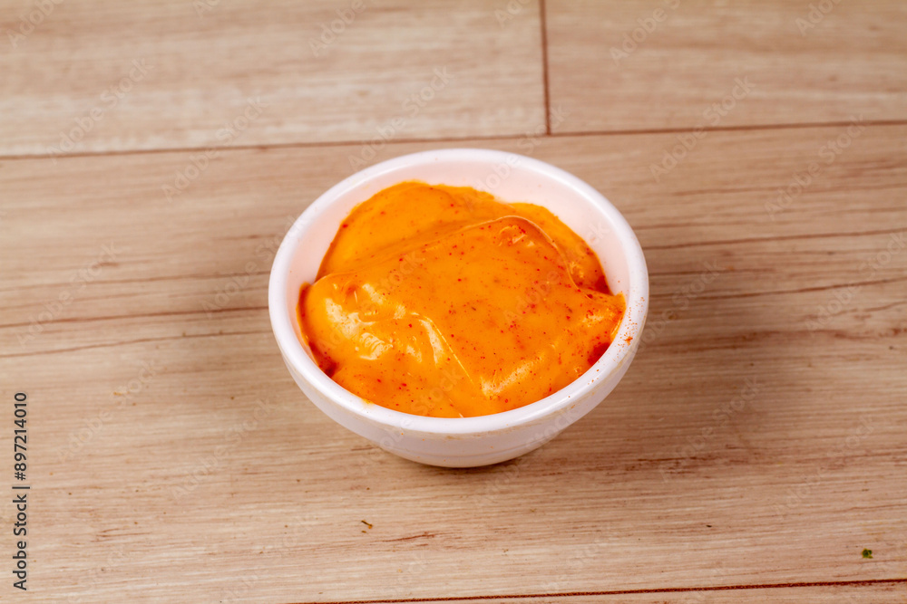 White Bowl of tasty chipotle sauce on wooden background White Bowl of tasty chipotle sauce on wooden background