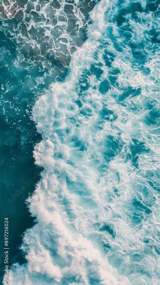 A beautiful blue wave with white foam crashing in the ocean A beautiful blue wave with white foam crashing in the ocean