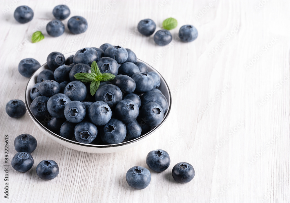 Fresh blueberries on a wooden white table, with copy space for text Fresh blueberries on a wooden white table, with copy space for text