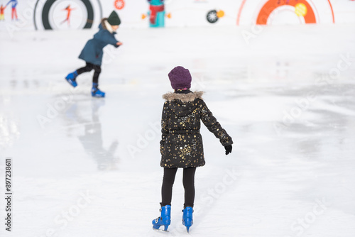 teenage girl skating outdoor, ice rink photo