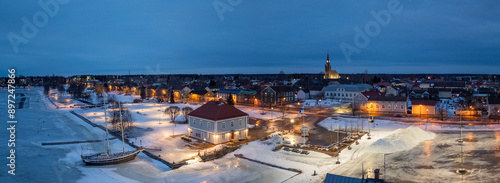 Lights of Raahe at wintertime. Frozen sea.