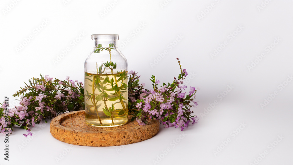 Fresh thyme and essential oil on the white background. Hair treatment concept. Close up Fresh thyme and essential oil on the white background. Hair treatment concept. Close up