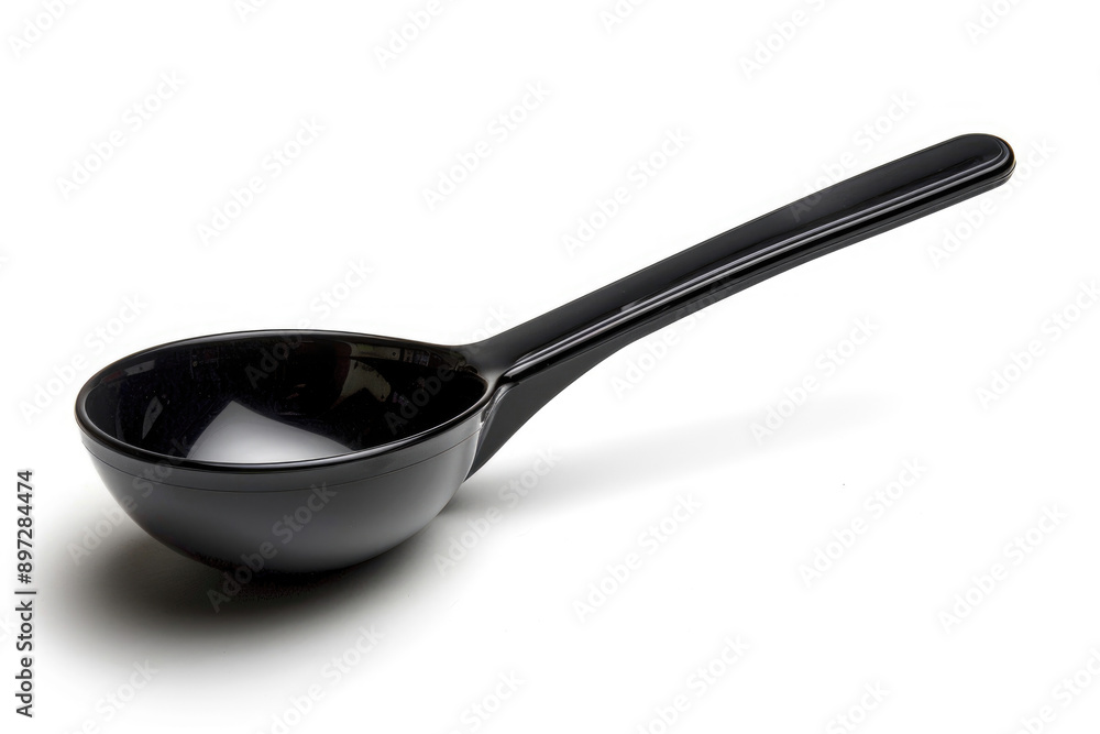 Black plastic soup ladle on a white background. Black plastic soup ladle on a white background.