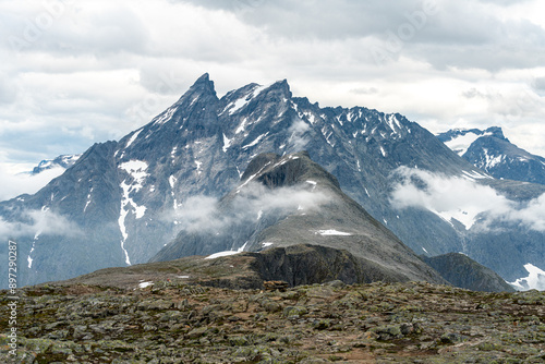 Romsdalseggen Ridge mountain peak  trail in Andalsnes Romsdal Norway with clouds and fog on a summer day photo