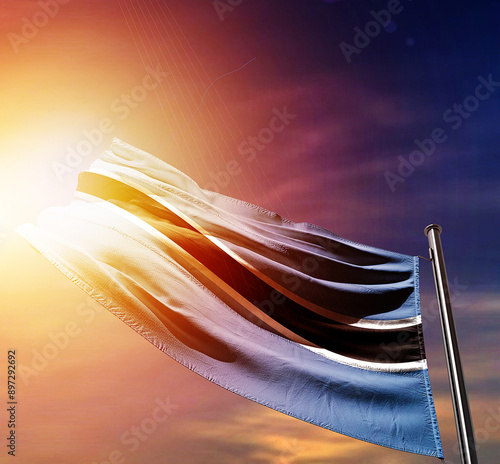 Botswana national flag waving in dramatic dark sunlight. Botswana national flag for independence day. photo