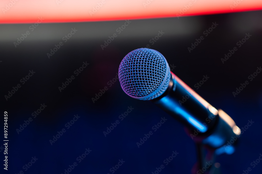 Detail of illuminated microphone in front of neutral background Detail of illuminated microphone in front of neutral background