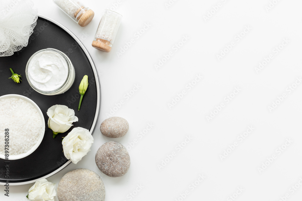 Spa set with cosmetic products with white flowers, top view Spa set with cosmetic products with white flowers, top view