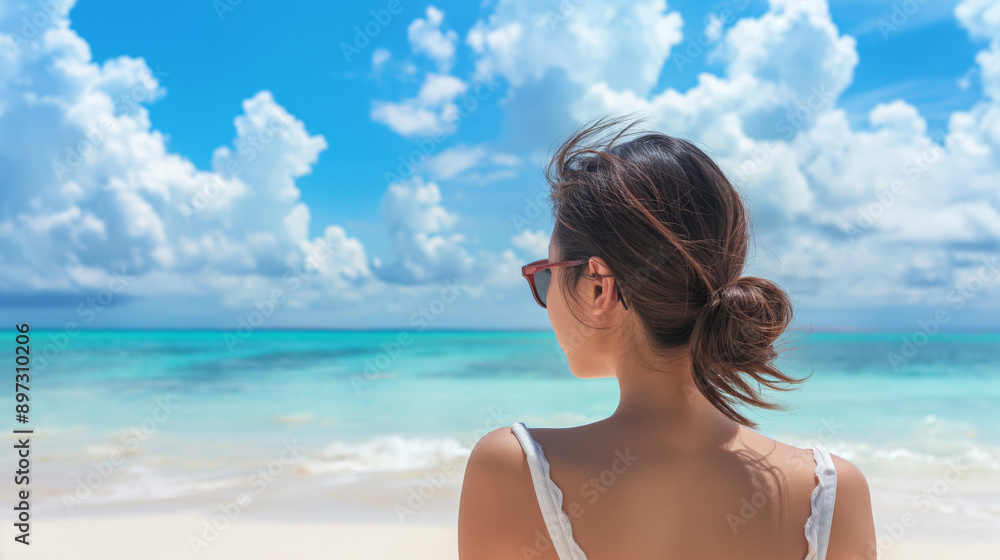 Back view portrait of a beautul young Asian woman relaxing on the beach Back view portrait of a beautul young Asian woman relaxing on the beach