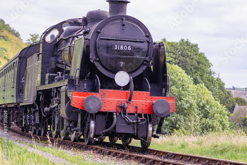 Discover a captivating steam engine chugging along a scenic railway track, showcasing the nostalgia and timeless elegance of classic train travel. Perfect for historical and transportation.