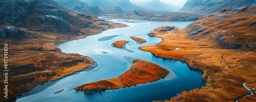 A winding river snaking its way through a valley, its waters reflecting the surrounding mountains.