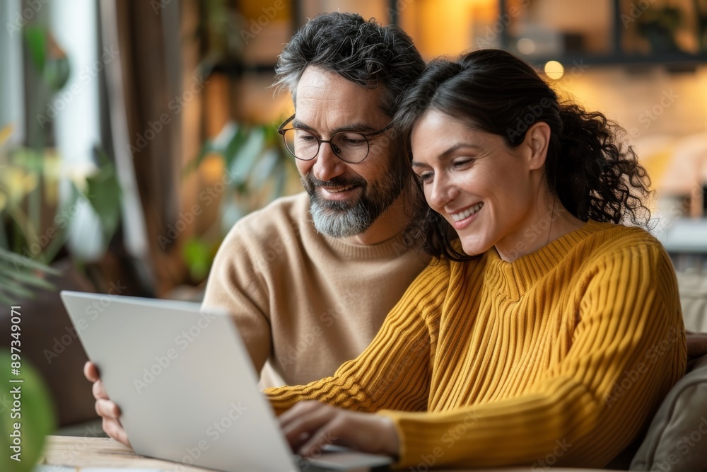 Portrait of a content couple in their 30s using a laptop together Portrait of a content couple in their 30s using a laptop together