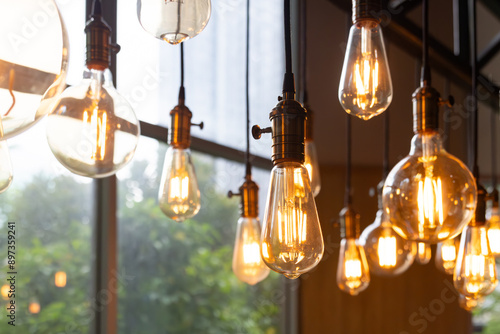 A bunch of light bulbs hanging from the ceiling, some of which are lit up