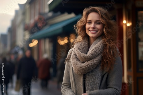 Portrait of a satisfied woman in her 30s dressed in a warm wool sweater over charming small town main street