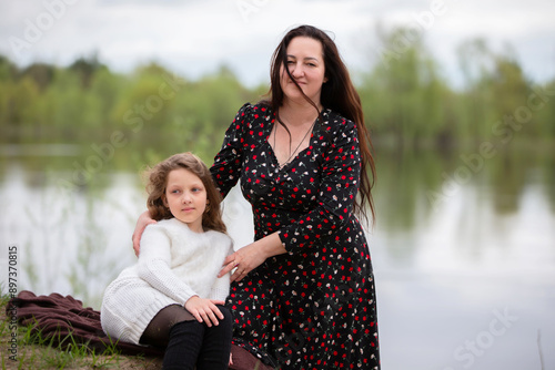 Mom and daughter enjoy a walk in the park on Mother's Day.