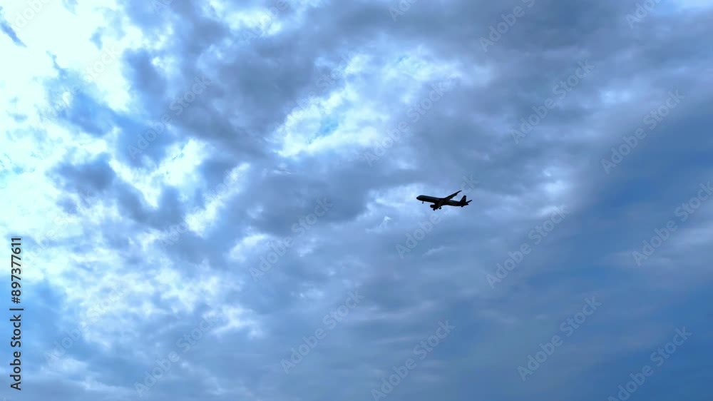 Silhouette of a passenger plane flying before landing on the background of evening sky Silhouette of a passenger plane flying before landing on the background of evening sky