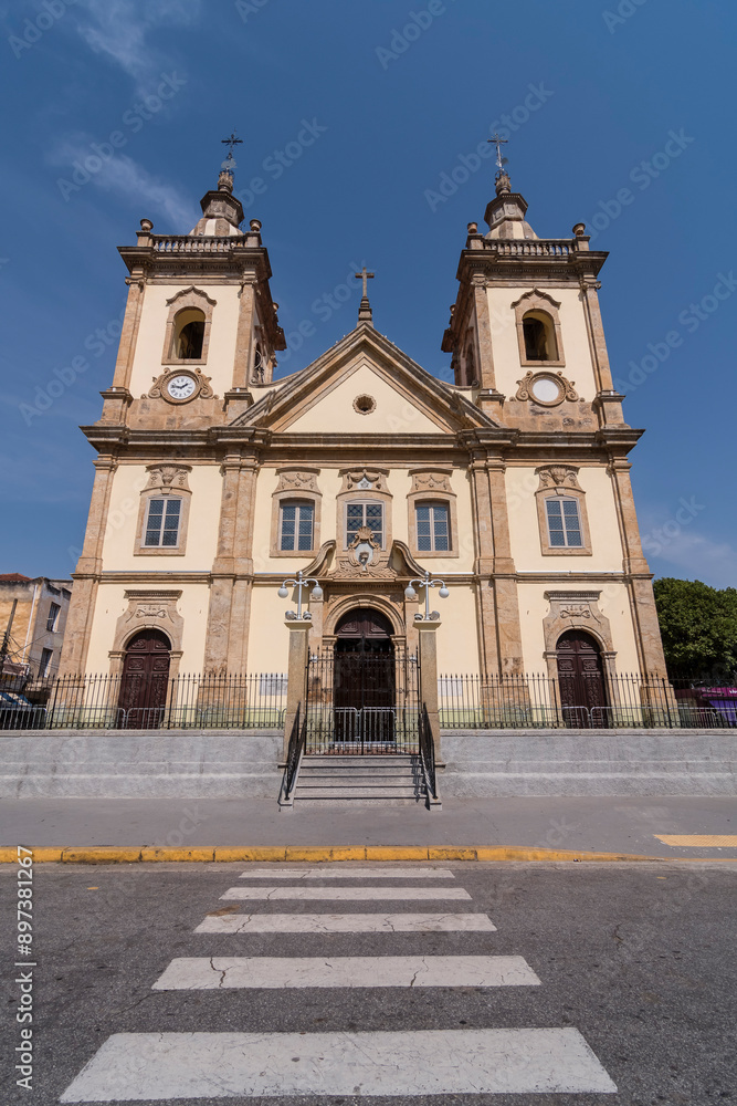 Fototapeta premium Aparecida, Brazil. Facade of the old Basilica of Nossa Senhora Aparecida in baroque architecture from 1888. Located in it is a national sanctuary. Background blue sky.