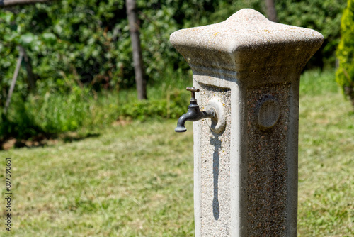 stone fountain in mountain context, drought concept